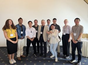 Group of people stand together for a photo