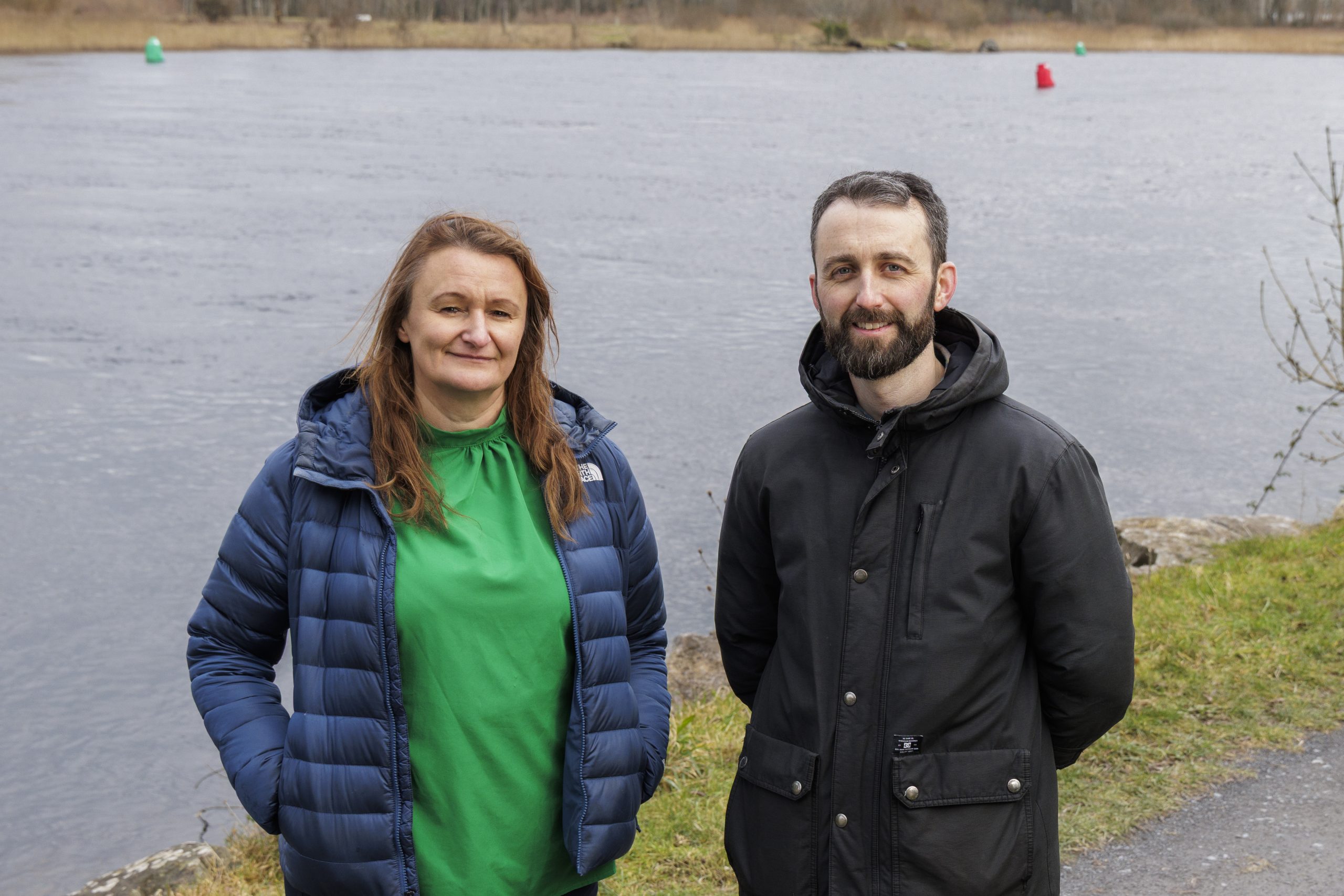 Dr Indiana Olbert and Dr Thomas McDermott standing beside a river