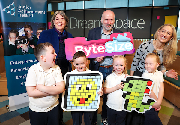 a photo of Students from St Columbanus NS in Dublin join Helen Raftery (Junior Achievement Ireland), James O'Connor (Microsoft) and Dr Ruth Abigail Freeman at the launch of new digital literacy programmes ByteSize and brAIn_waves