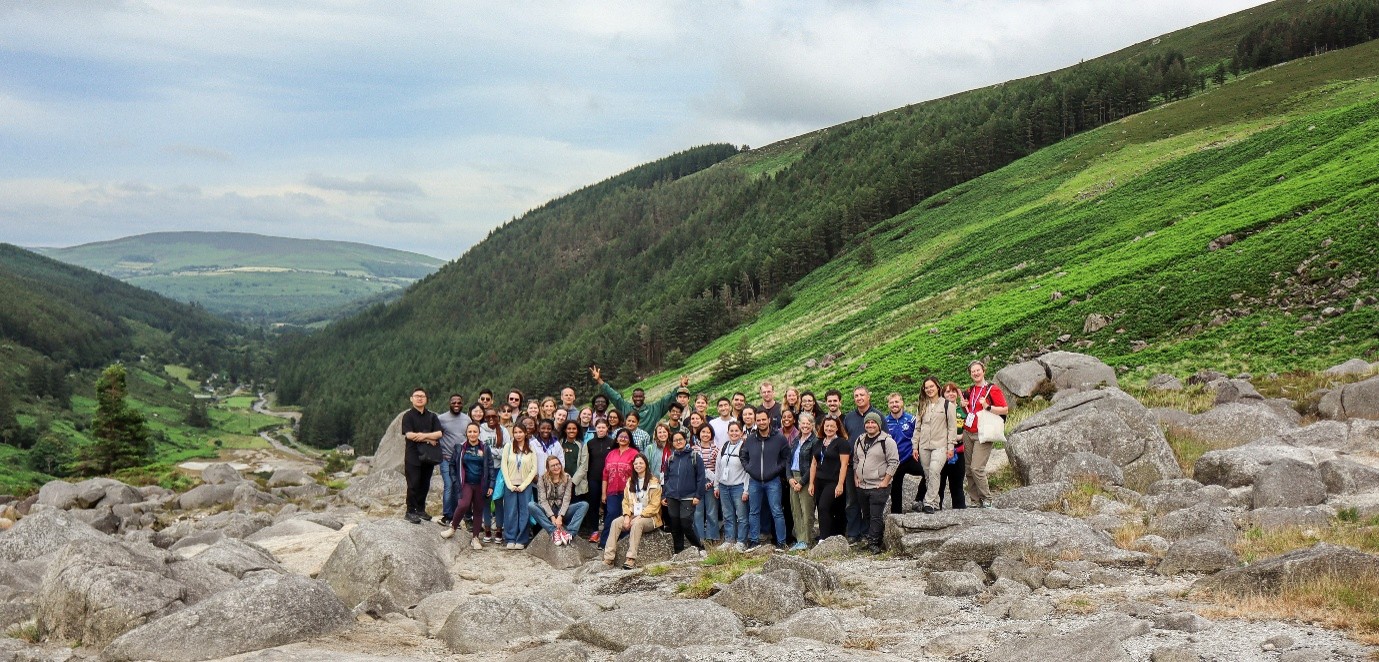 A group photo of members of the ReSToRE international summer school on sustainability on a mountainside.
